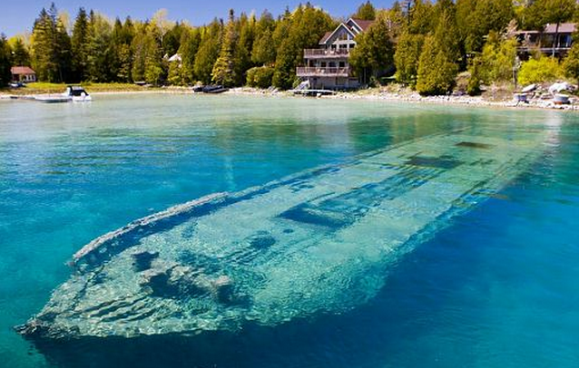http://www.dailymail.co.uk/news/article-2275055/World-s-beautiful-shipwreck-Haunting-hull-Sweepstakes-lies-just-TWENTY-FEET-clear-blue-water-Ontario-lake-sank-1885.html#axzz2K52CUvPB